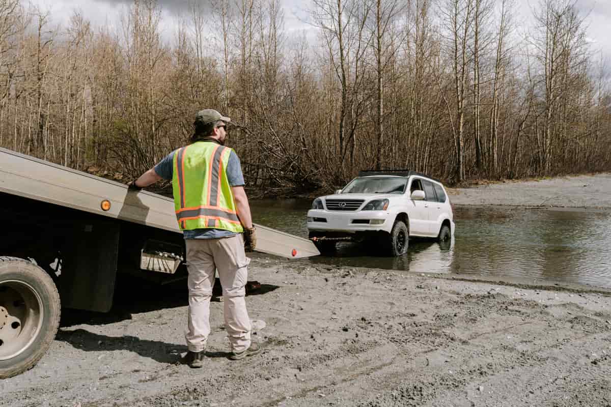 Tow operator preparing a flatbed recovery near the roadway