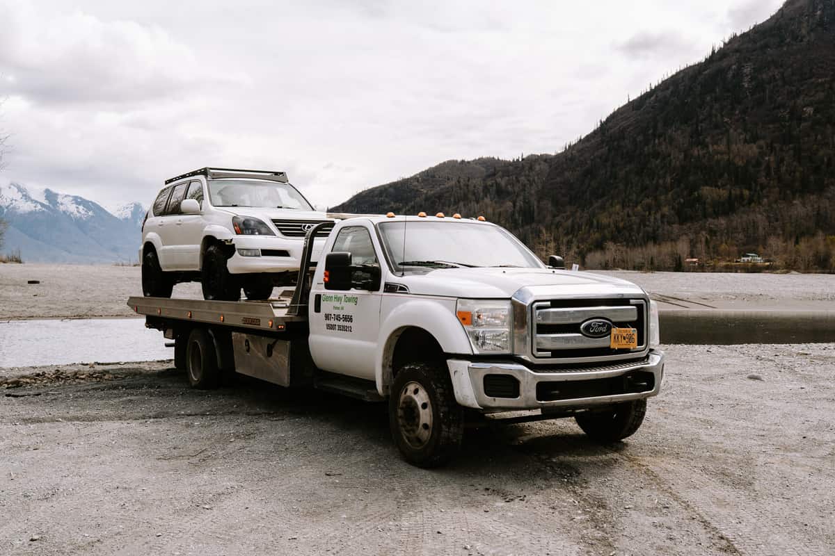 Flatbed towing service transporting an SUV near Palmer Alaska