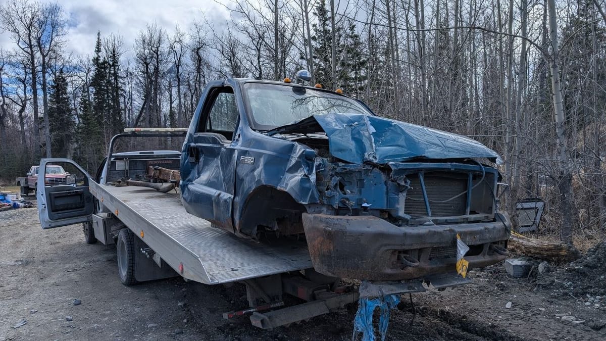 Vehicle loaded on a flatbed tow truck for removal